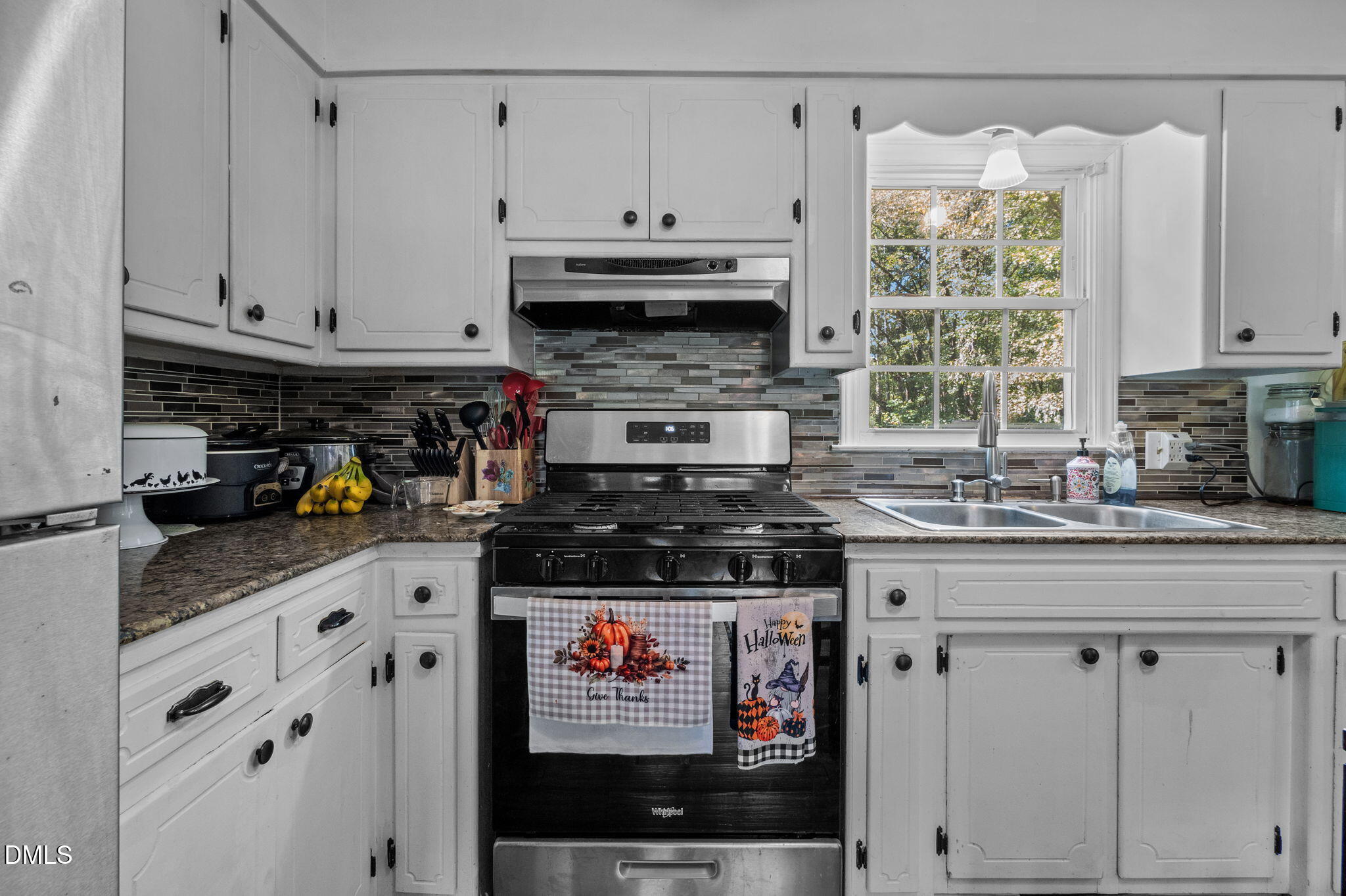 670 Tingen Mine Road Roxboro, NC 27574 - Photo 7 of 30 a kitchen with granite countertop a stove a sink and a refrigerator