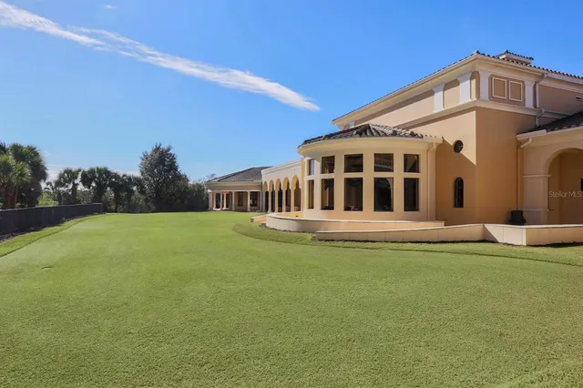 a view of a swimming pool with a lawn chair and palm trees