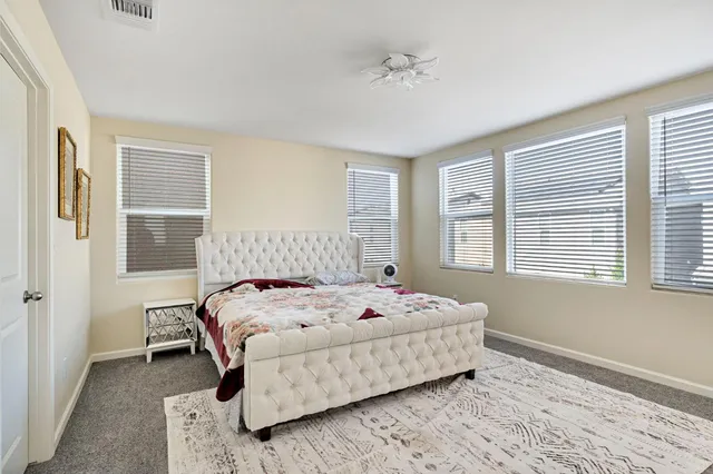 a bedroom with a bed and window