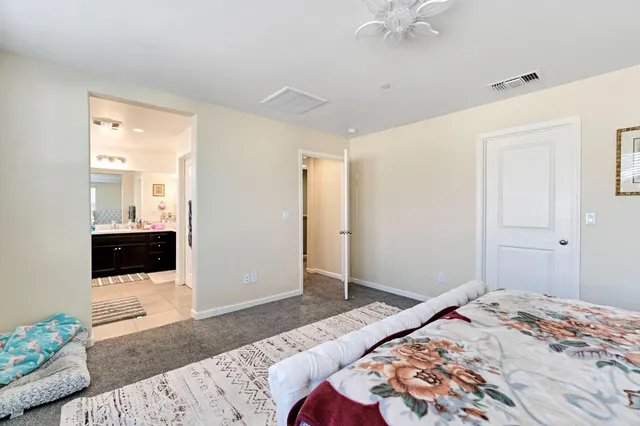 a bedroom with a bed and a view of bathroom