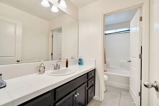a bathroom with a sink a mirror and a bathtub