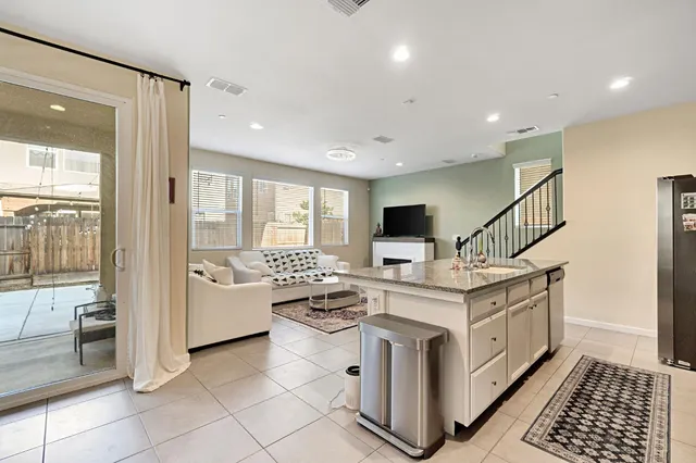 a open kitchen with stainless steel appliances kitchen island granite countertop a stove and a sink