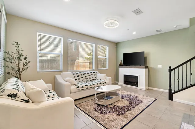 a living room with furniture and a fireplace