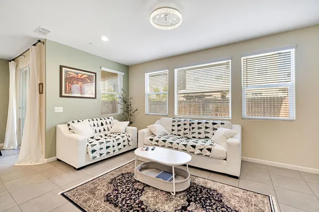 a bedroom with furniture and a large window