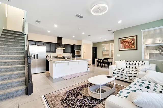 a living room with furniture and kitchen view