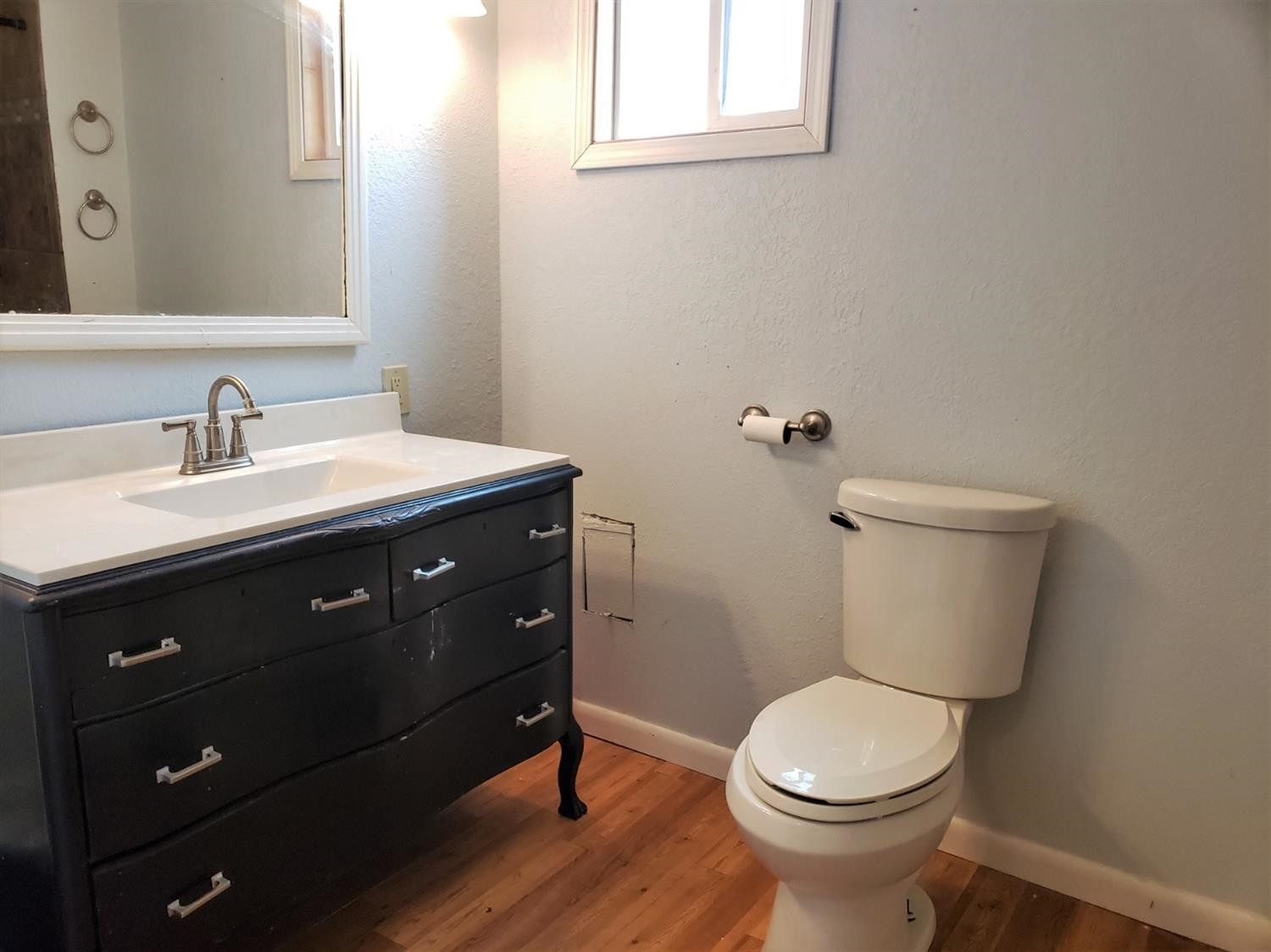 1401 Ave J Abernathy, TX 79311 - Photo 17 of 23 a bathroom with a toilet a sink and mirror