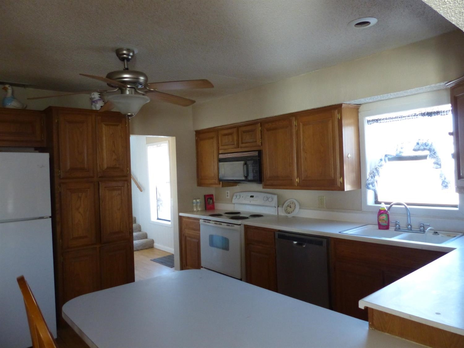 1401 Ave J Abernathy, TX 79311 - Photo 10 of 23 a kitchen with stainless steel appliances granite countertop a sink a stove a refrigerator cabinets and a dining table