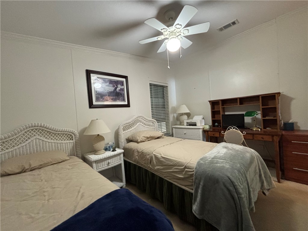 6171 98th Road Sebastian, FL 32958 - Photo 13 of 14 a bedroom with a bed and a chandelier