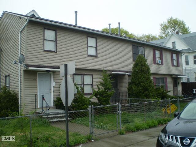 407 Logan Street Bridgeport, CT 06607 - Photo 1 of 1 a front view of a house with garden