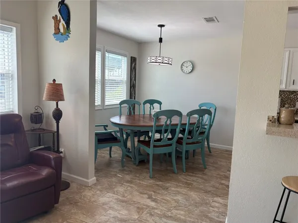 a view of a dining room with furniture and window