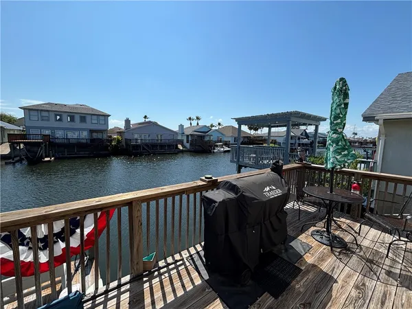 a balcony with wooden floor table and chairs