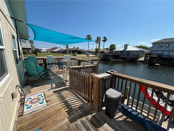 a balcony with wooden floor outdoor seating and outdoor seating