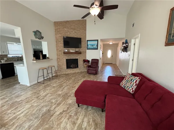 a living room with furniture a fireplace and a flat screen tv