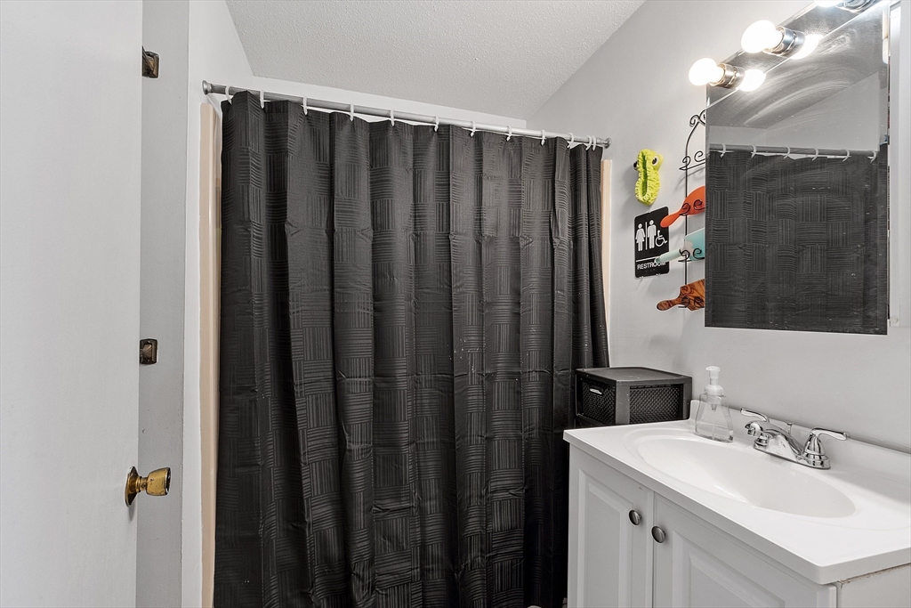 168 Ayer Road, Unit F3 Shirley, MA 01464 - Photo 22 of 36 a bathroom with a sink vanity and mirror
