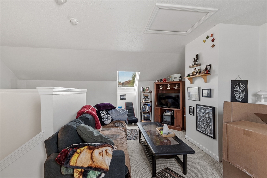 168 Ayer Road, Unit F3 Shirley, MA 01464 - Photo 24 of 36 a living room with furniture and a flat screen tv