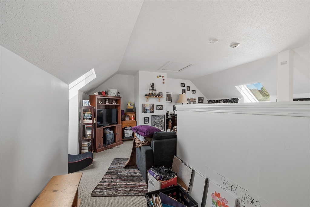 168 Ayer Road, Unit F3 Shirley, MA 01464 - Photo 25 of 36 a room with furniture a air conditioner vent and a window