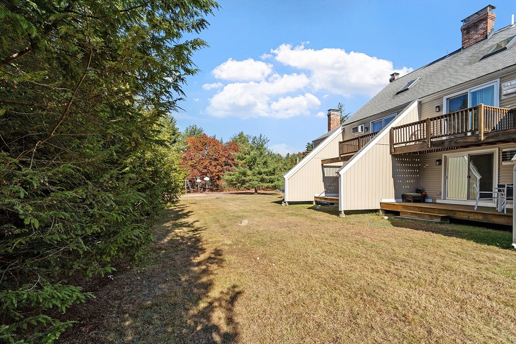 168 Ayer Road, Unit F3 Shirley, MA 01464 - Photo 31 of 36 a view of a house with backyard and a tree