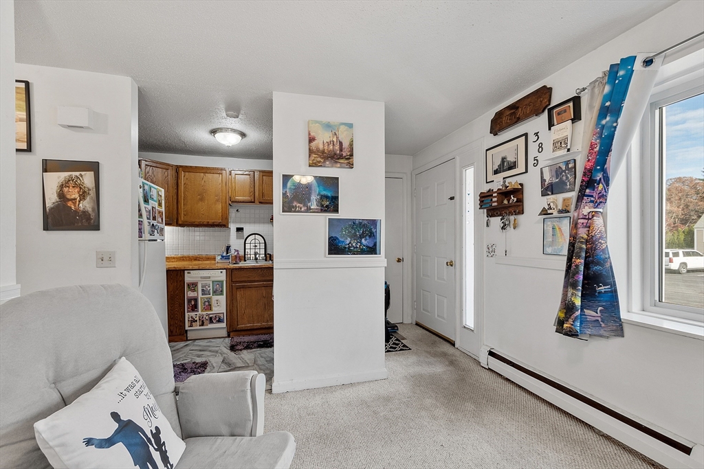 168 Ayer Road, Unit F3 Shirley, MA 01464 - Photo 7 of 36 a living room with furniture and a flat screen tv