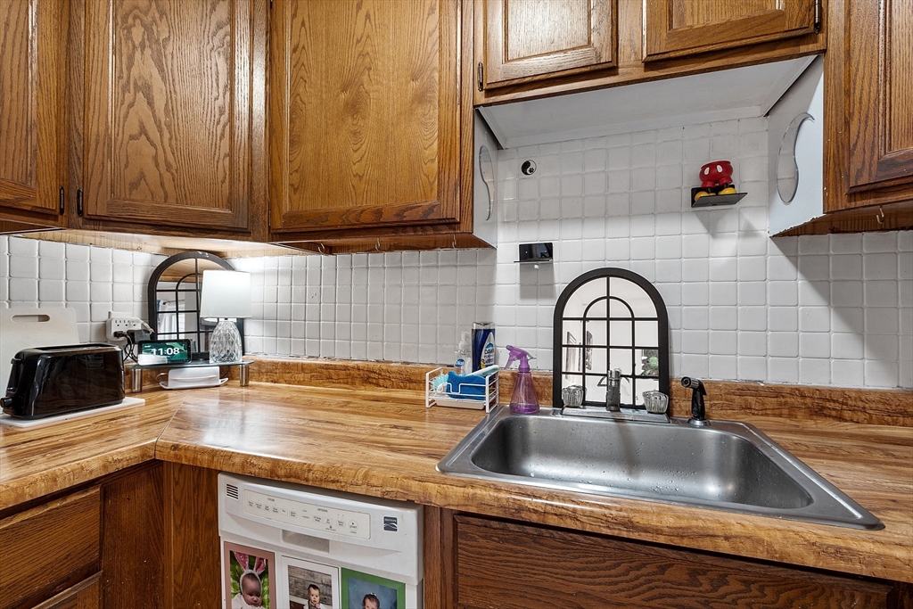 168 Ayer Road, Unit F3 Shirley, MA 01464 - Photo 10 of 36 a kitchen with granite countertop a sink and a stove