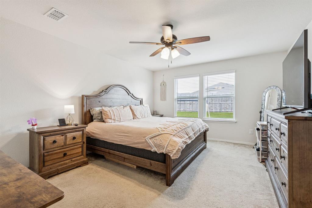 1207 Perrin Drive Forney, TX 75126 - Photo 11 of 20 a bedroom with a bed dresser and a window