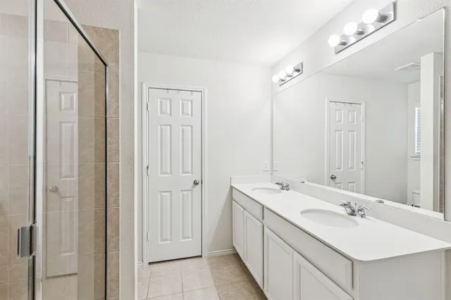 a bathroom with a double vanity sink and a mirror