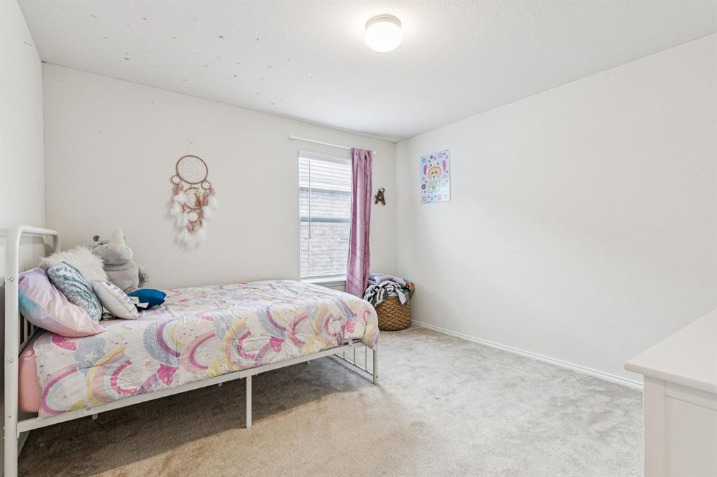 1207 Perrin Drive Forney, TX 75126 - Photo 15 of 20 a bedroom with a bed and a window