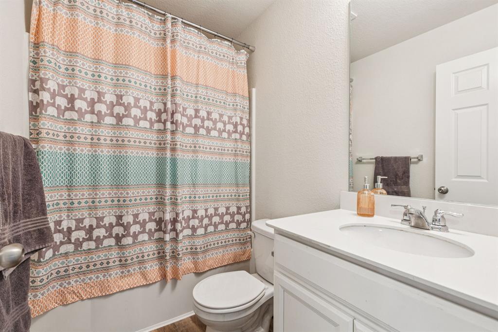 1207 Perrin Drive Forney, TX 75126 - Photo 17 of 20 a bathroom with a sink toilet and shower