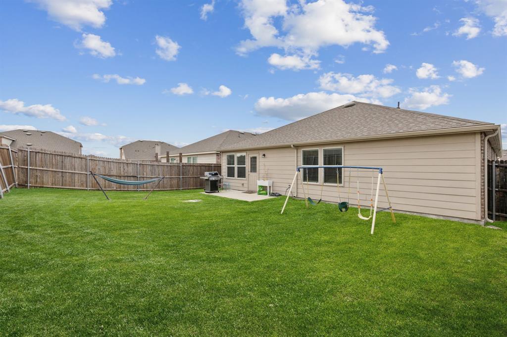1207 Perrin Drive Forney, TX 75126 - Photo 19 of 20 a view of an house with backyard and garden