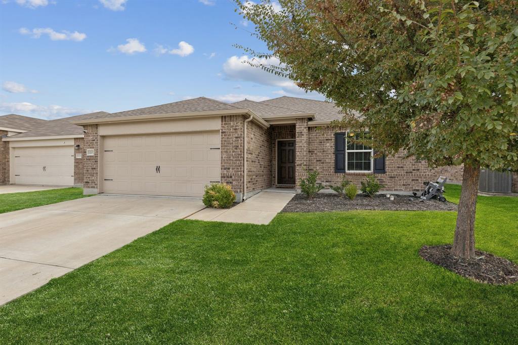 1207 Perrin Drive Forney, TX 75126 - Photo 20 of 20 a front view of a house with a garden and yard