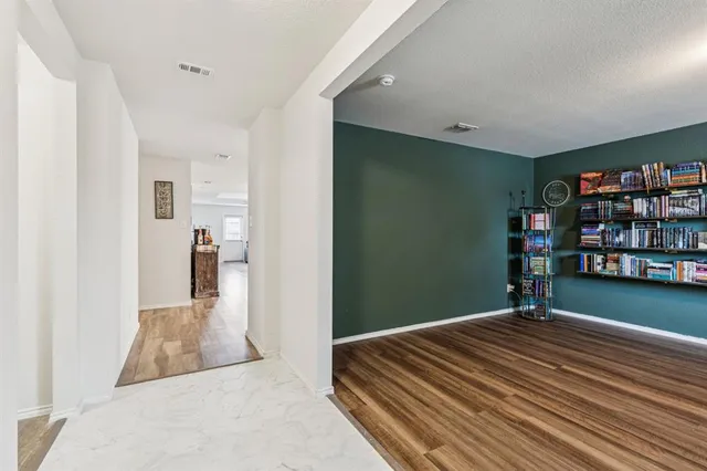 a bedroom with bed and a book shelf