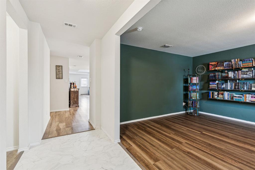 1207 Perrin Drive Forney, TX 75126 - Photo 2 of 20 a bedroom with bed and a book shelf