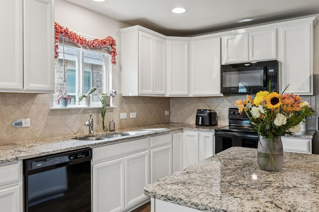 1207 Perrin Drive Forney, TX 75126 - Photo 6 of 20 a kitchen with a sink a stove and cabinets
