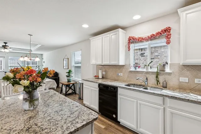 a kitchen with a sink a microwave and cabinets