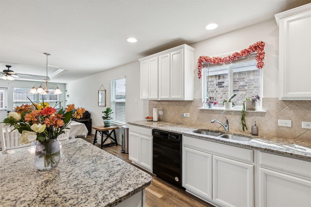 1207 Perrin Drive Forney, TX 75126 - Photo 7 of 20 a kitchen with a sink a microwave and cabinets