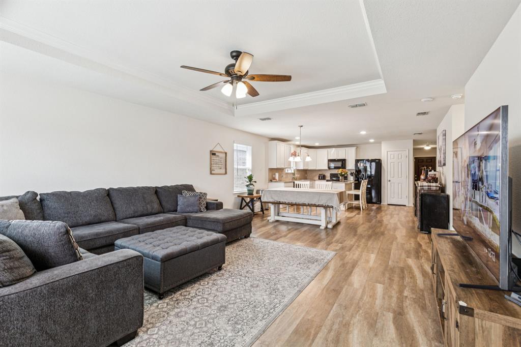 1207 Perrin Drive Forney, TX 75126 - Photo 9 of 20 a living room with furniture and a flat screen tv