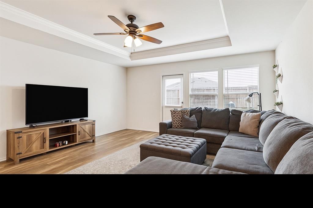 1207 Perrin Drive Forney, TX 75126 - Photo 10 of 20 a living room with furniture and a flat screen tv