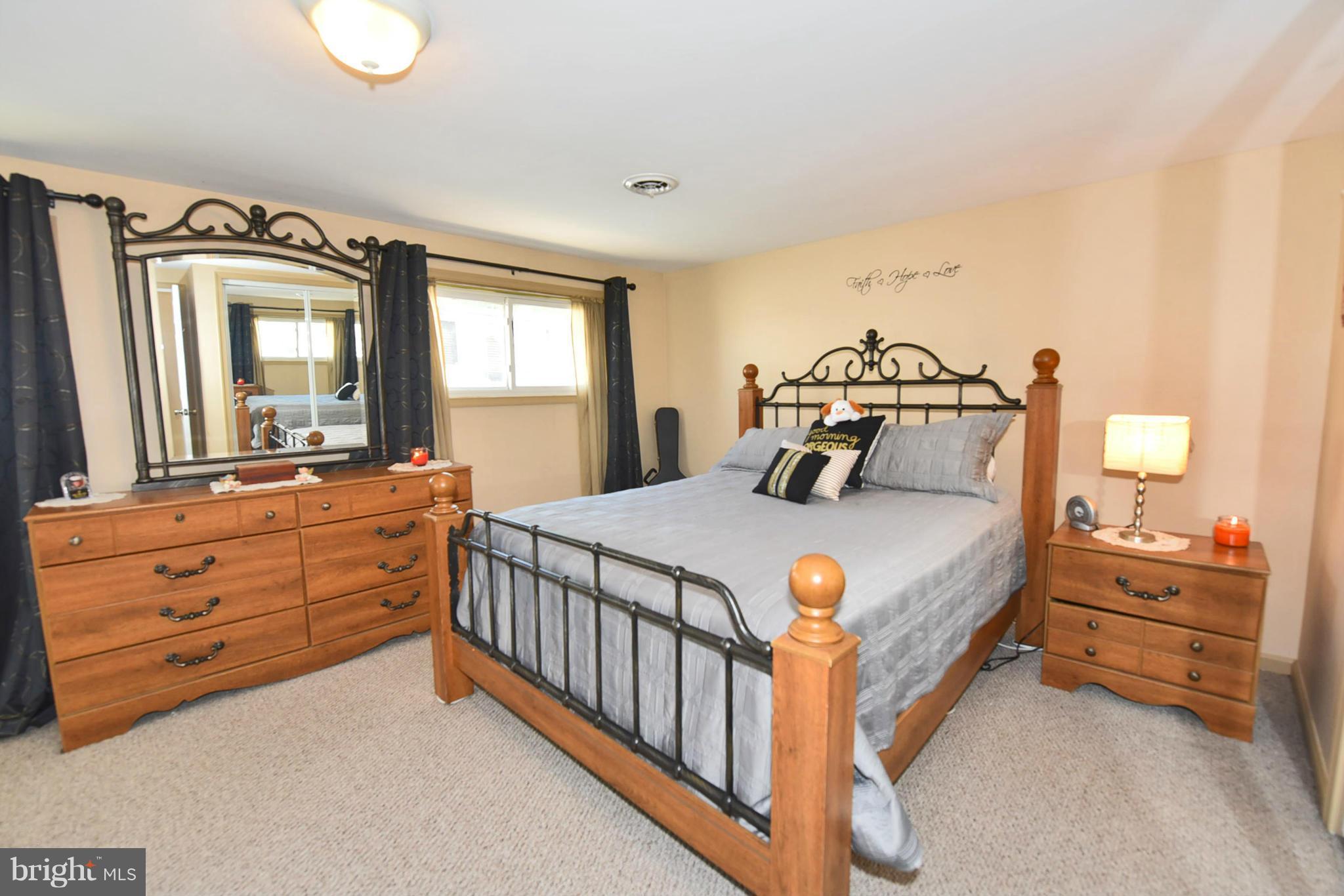 7124 Greenbank Road Baltimore, MD 21220 - Photo 13 of 30 a bedroom with a bed and a dresser