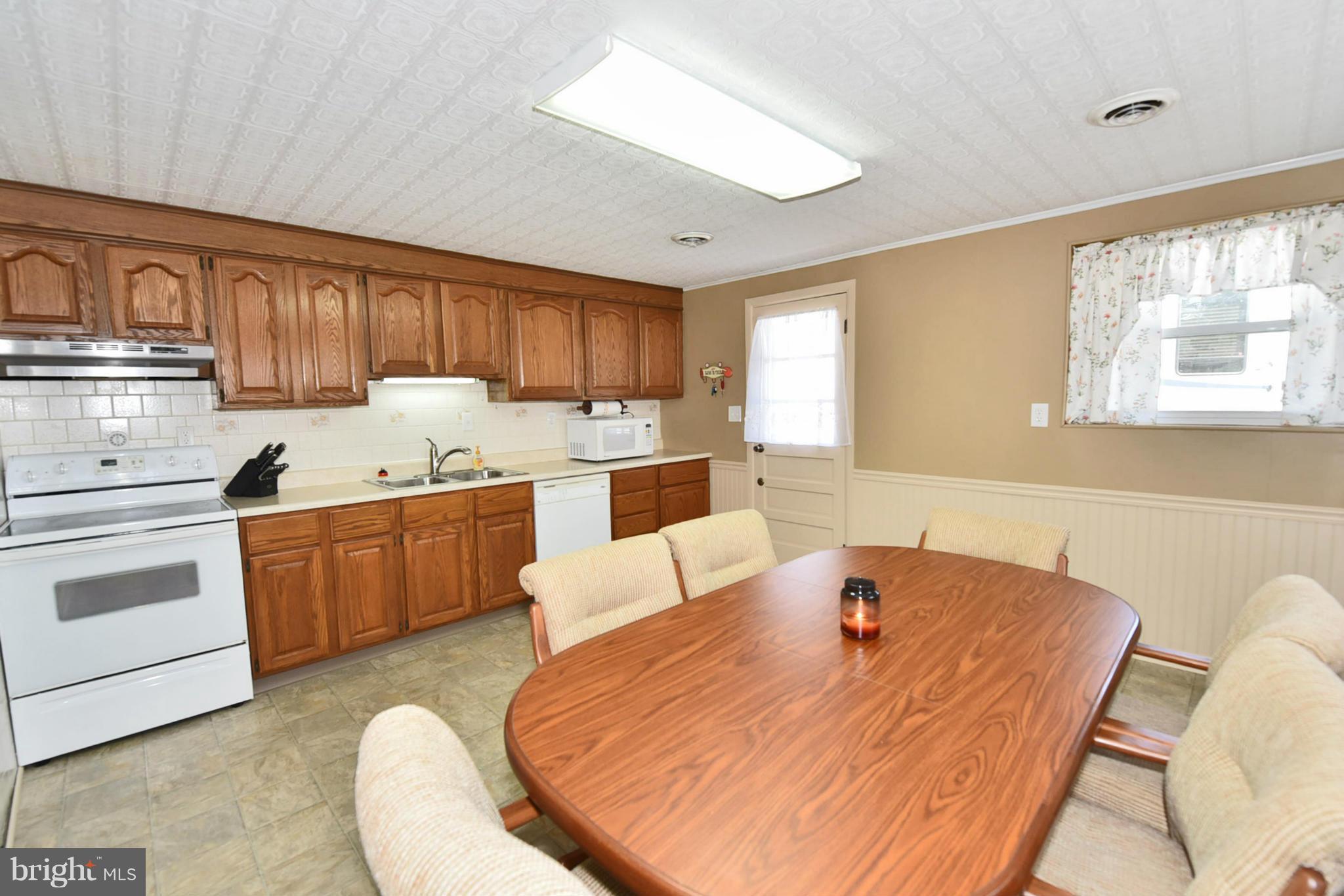 7124 Greenbank Road Baltimore, MD 21220 - Photo 24 of 30 a living room with stainless steel appliances furniture a rug and a kitchen view