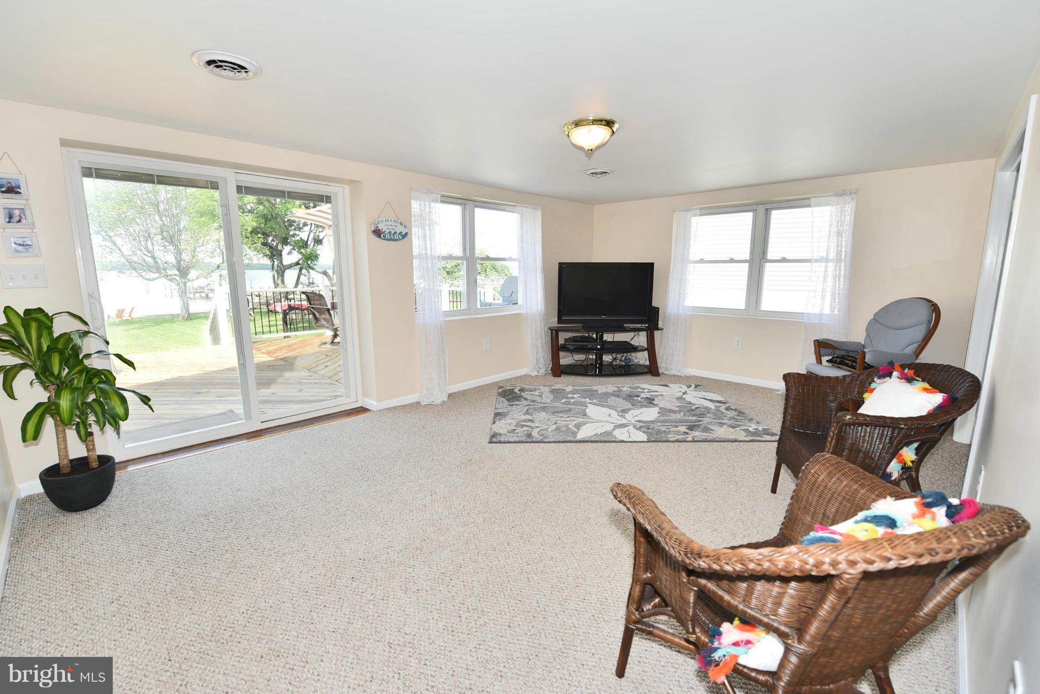 7124 Greenbank Road Baltimore, MD 21220 - Photo 8 of 30 a living room with furniture a flat screen tv and a large window