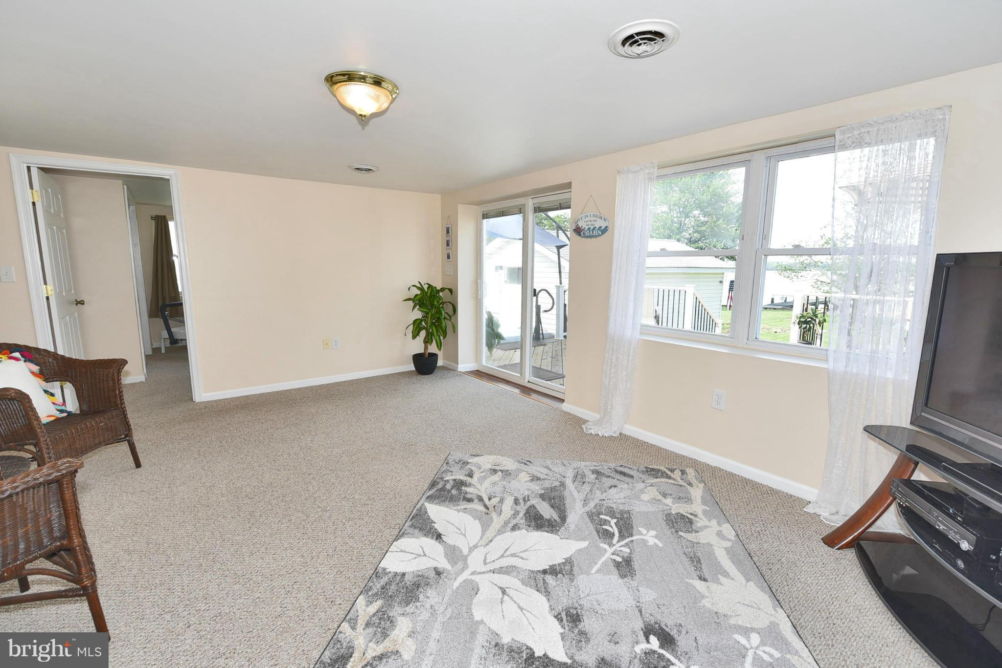 7124 Greenbank Road Baltimore, MD 21220 - Photo 10 of 30 a view of a livingroom with wooden floor and a window