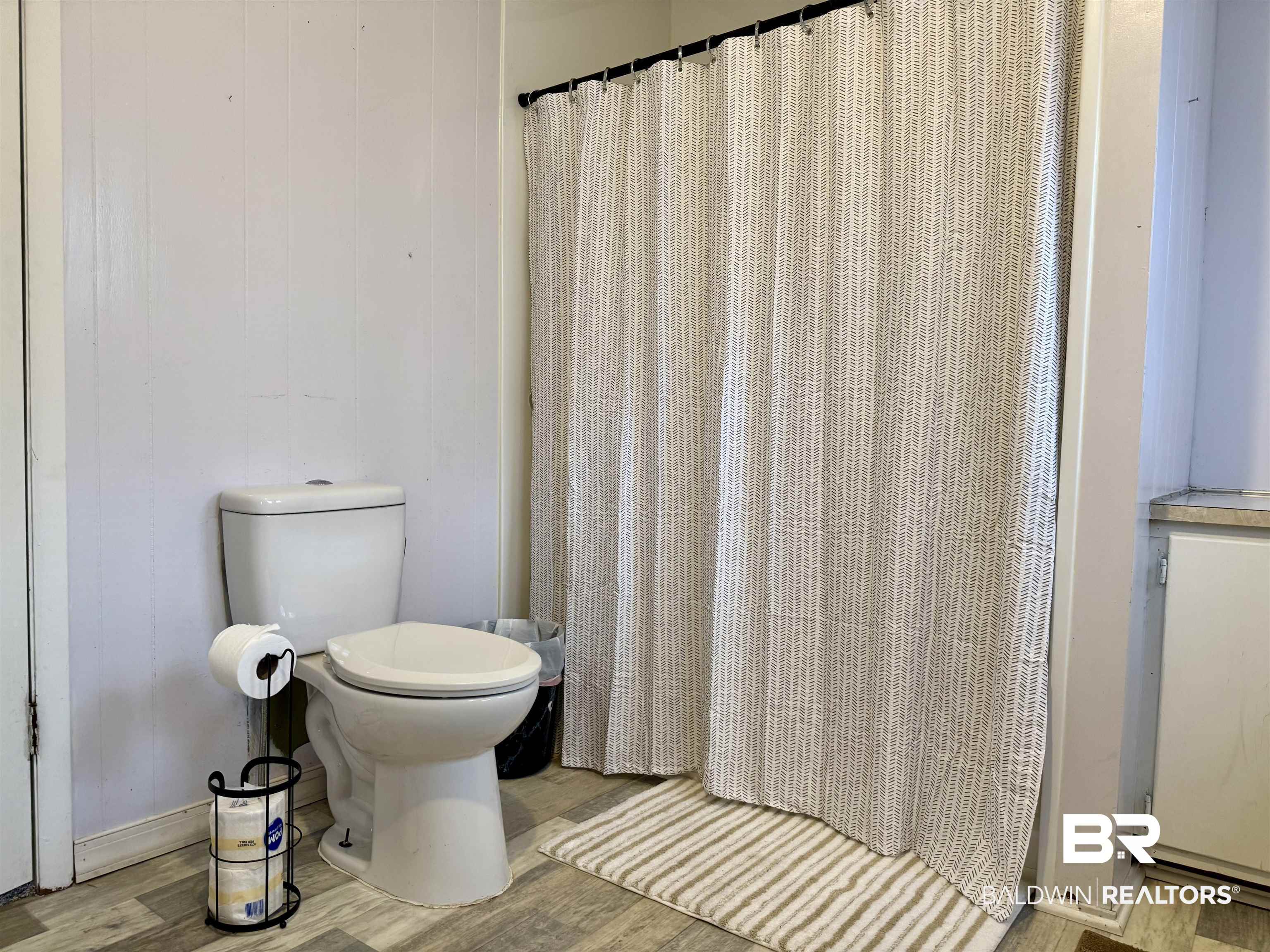 826 West Side Road Castleberry, AL 36432 - Photo 21 of 34 Full bath with light wood-style floors and curtained shower