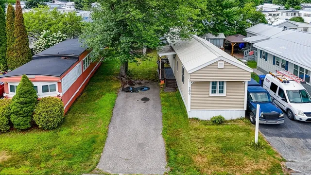 a aerial view of a house with a yard and potted plants