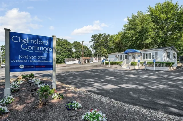 a view of a house with a yard and wooden fence