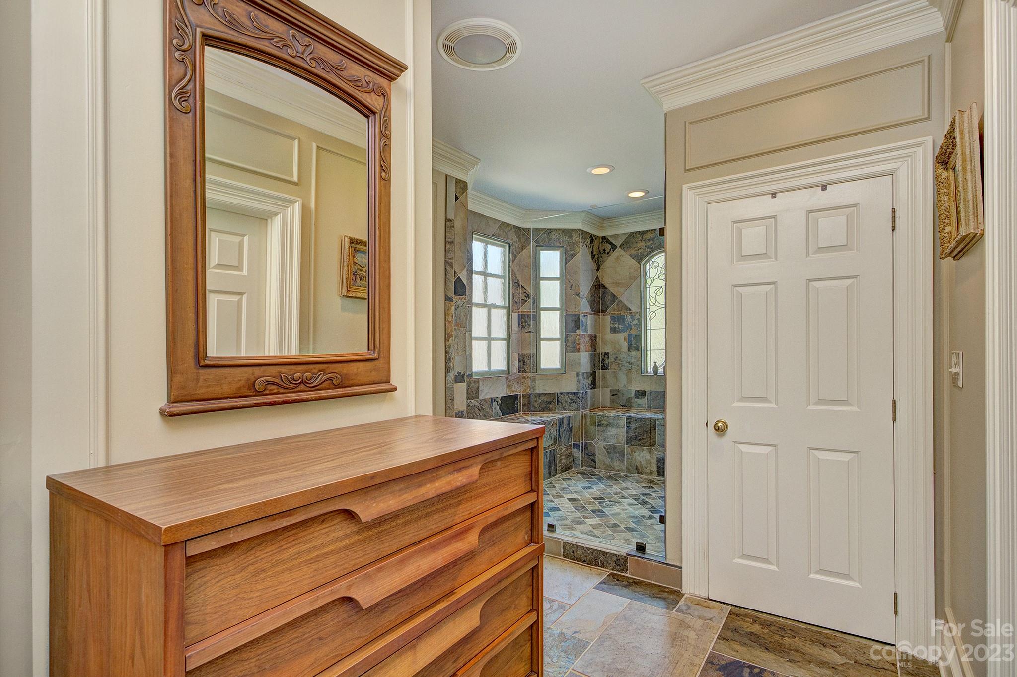 4500 Nora's Path Road Charlotte, NC 28226 - Photo 22 of 48 a bathroom with a sink a mirror and a shower