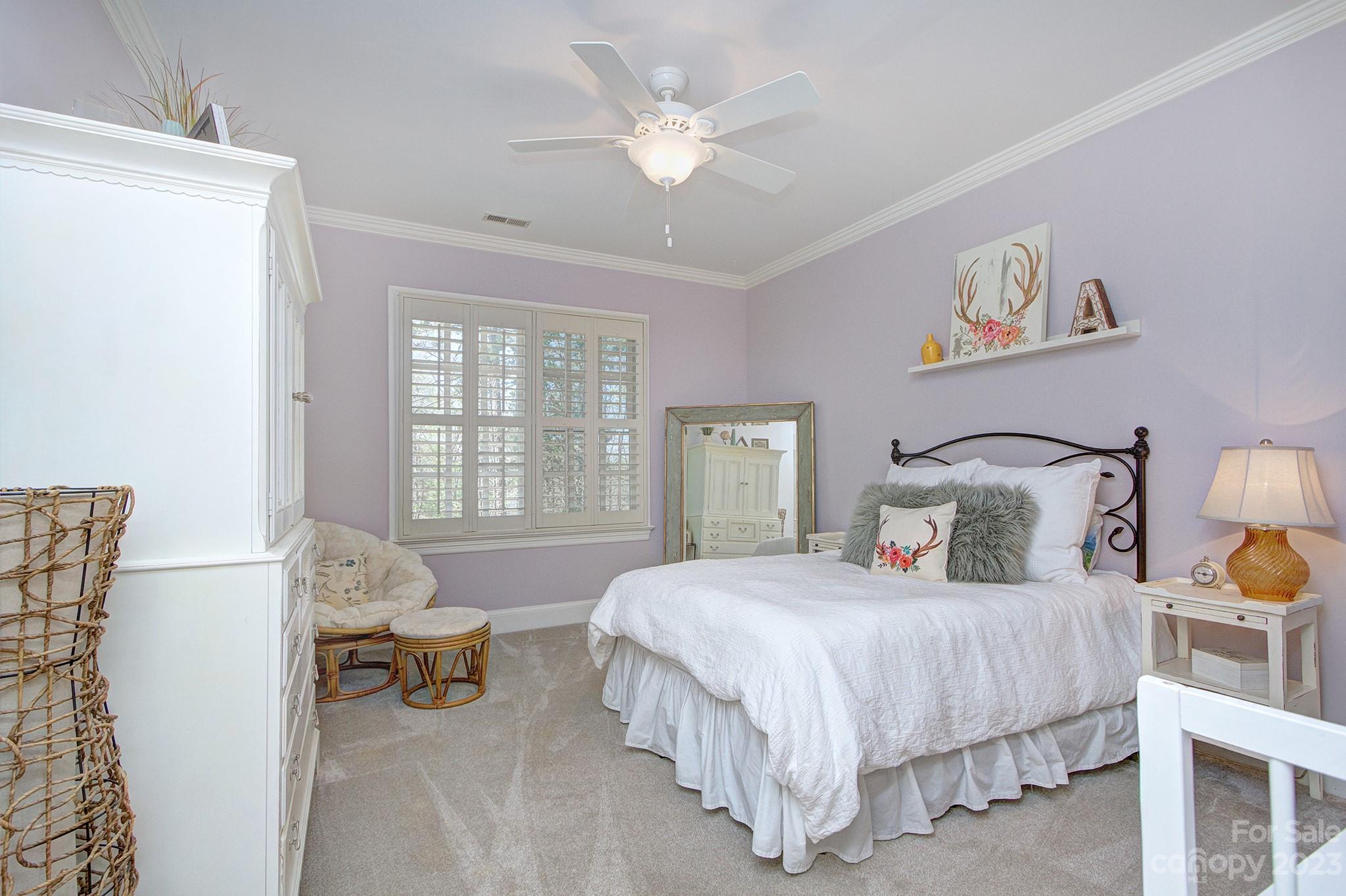 4500 Nora's Path Road Charlotte, NC 28226 - Photo 28 of 48 a bedroom with a bed and a chandelier