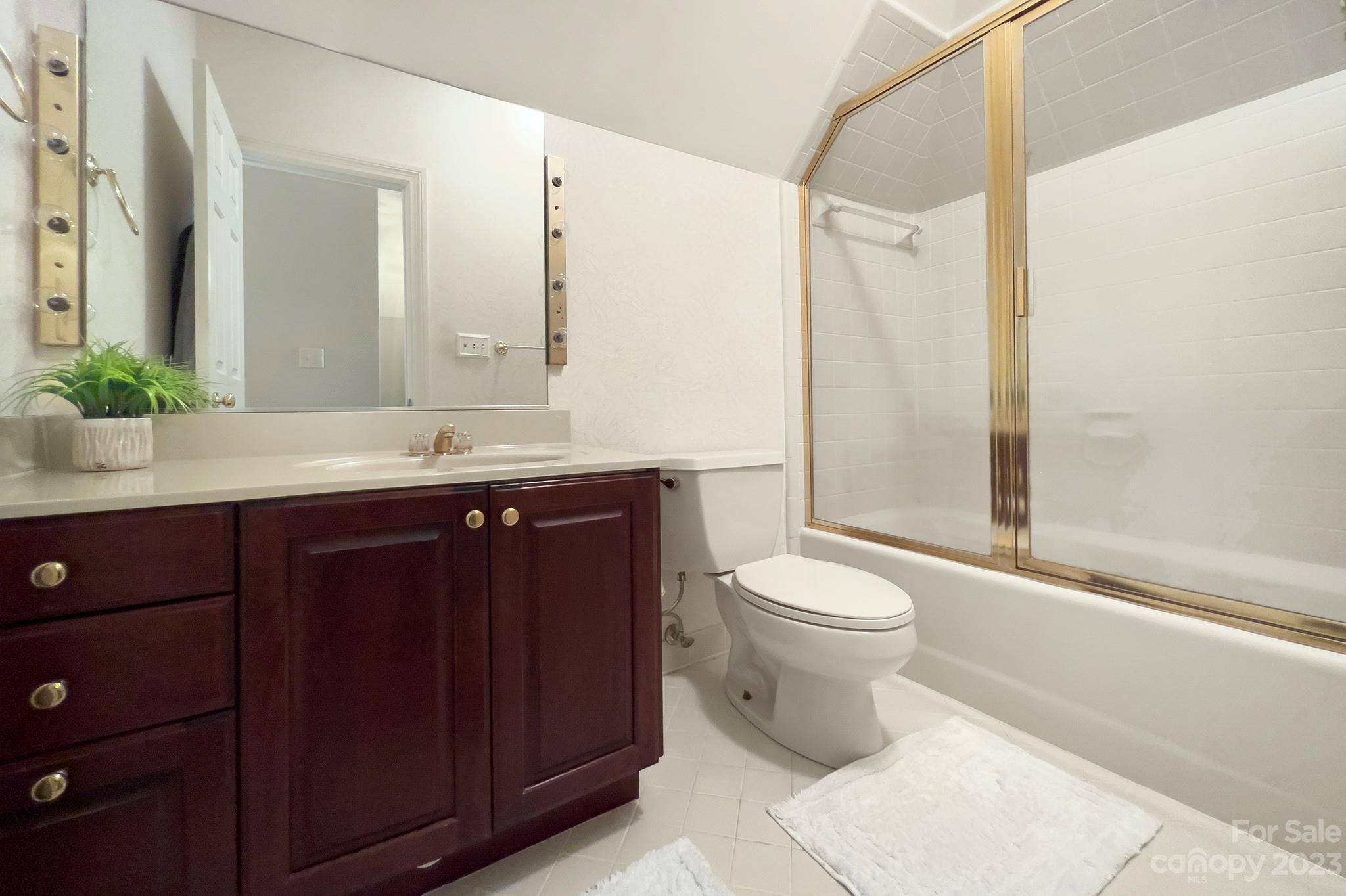 4500 Nora's Path Road Charlotte, NC 28226 - Photo 36 of 48 a bathroom with a granite countertop sink toilet mirror and shower