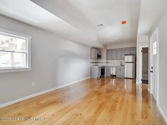 a view of kitchen with furniture and wooden floor