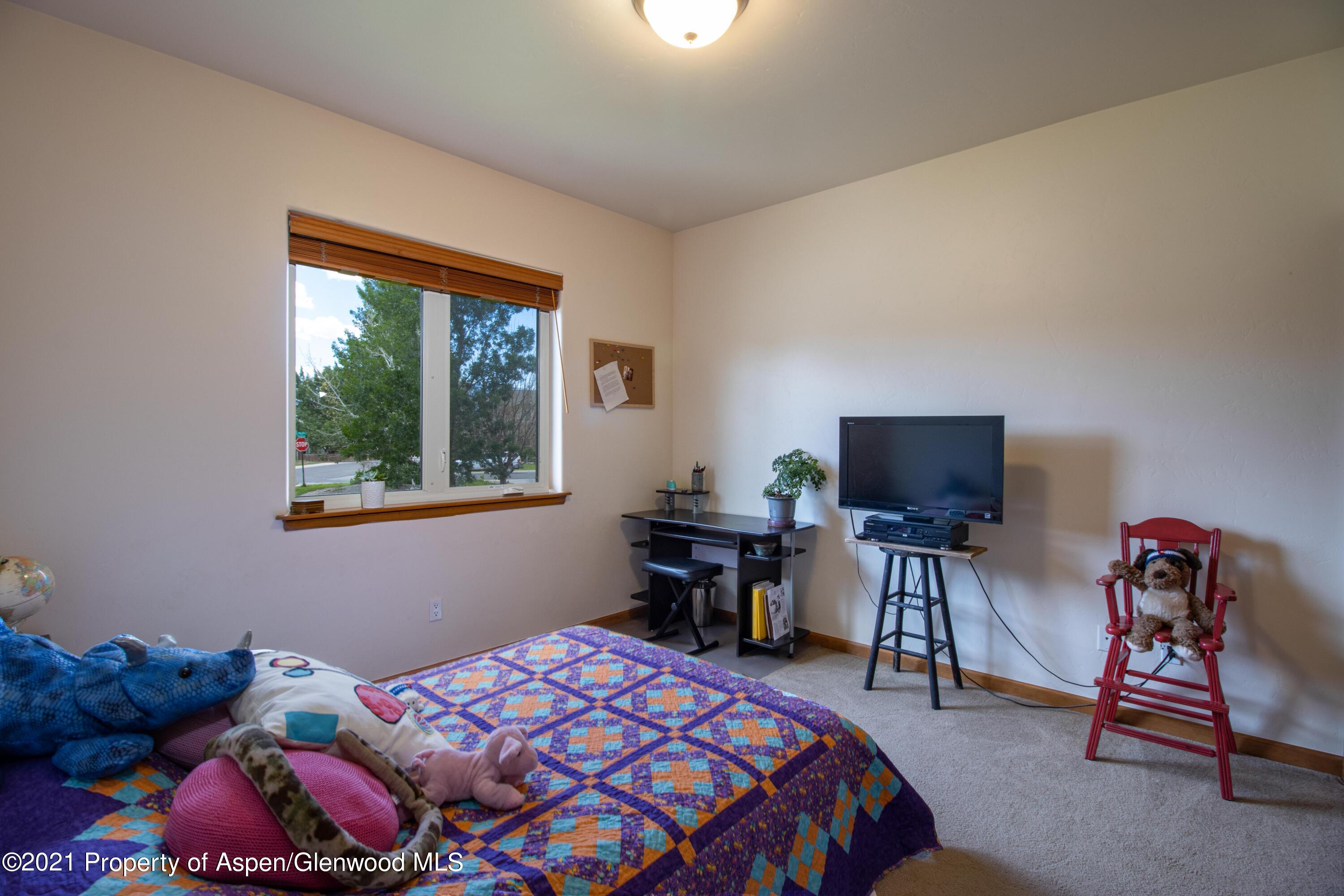 1904 Promontory Circle Rifle, CO 81650 - Photo 12 of 20 a bedroom with a bed and a tv