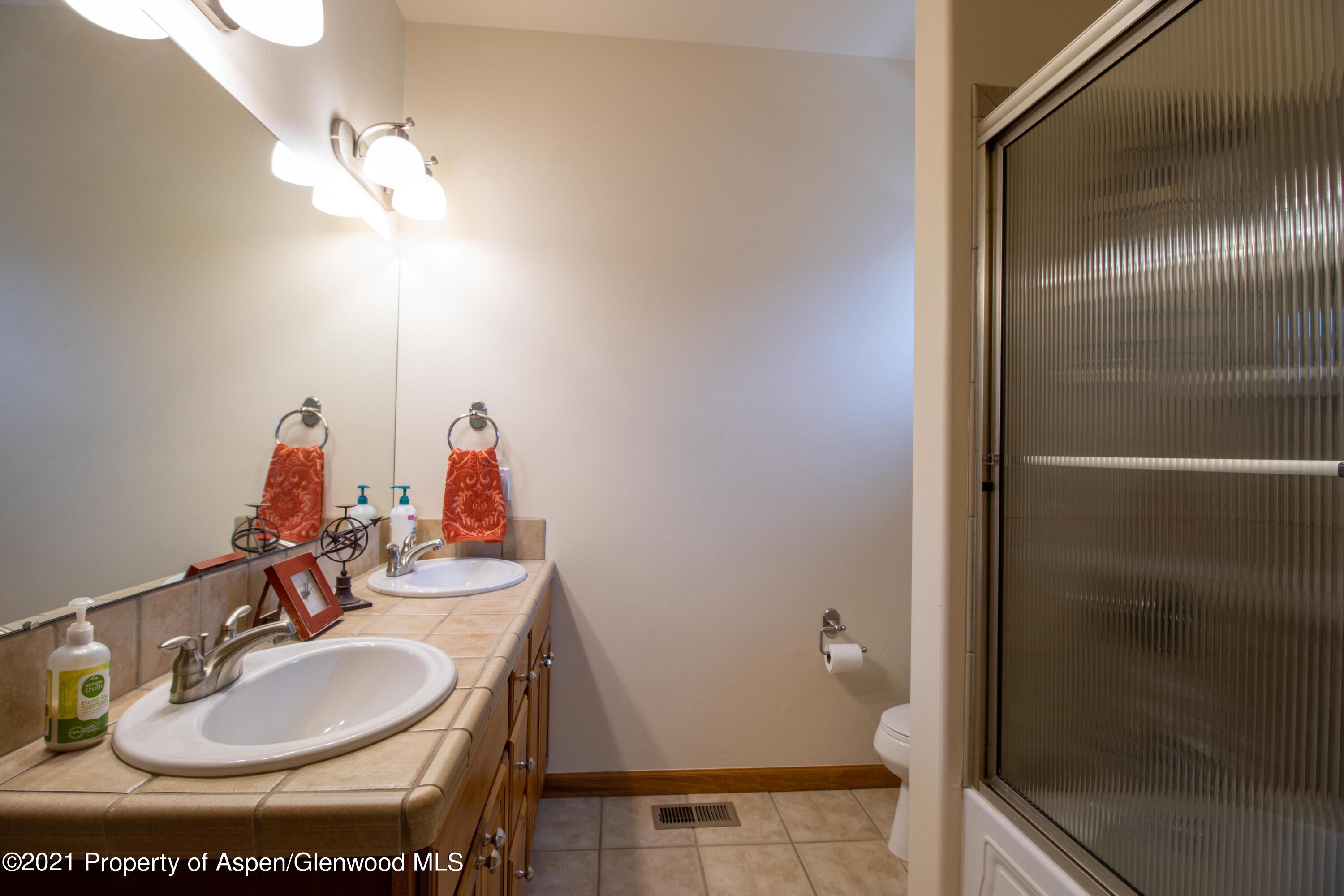 1904 Promontory Circle Rifle, CO 81650 - Photo 13 of 20 a bathroom with a sink and a mirror
