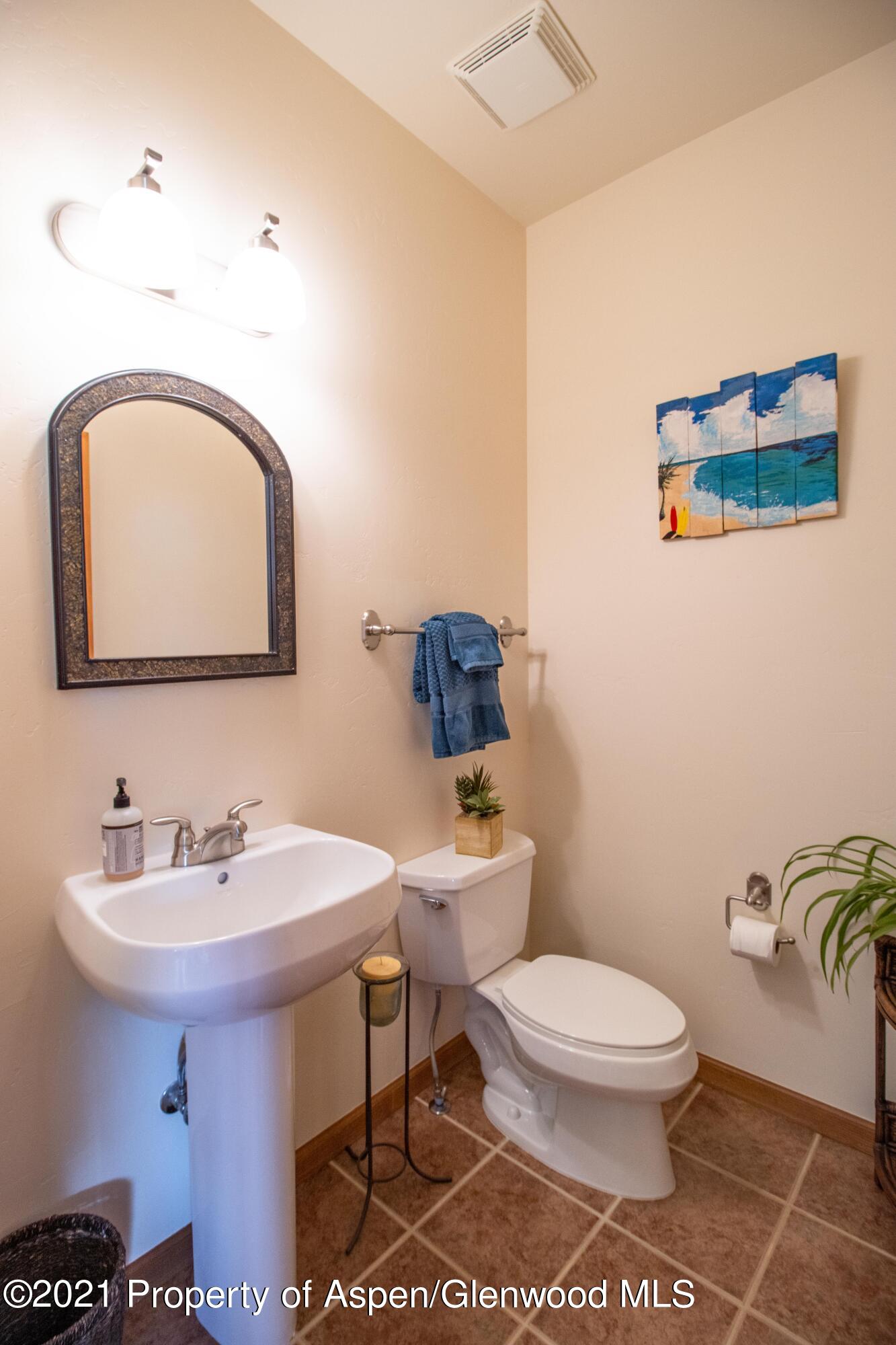1904 Promontory Circle Rifle, CO 81650 - Photo 14 of 20 a bathroom with a toilet sink and mirror